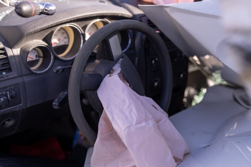 Deployed driver airbag inside a vehicle after a severe car crash.