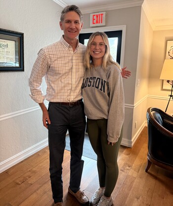 Tampa personal injury lawyer John C. Austin poses with a recent client of the firm.