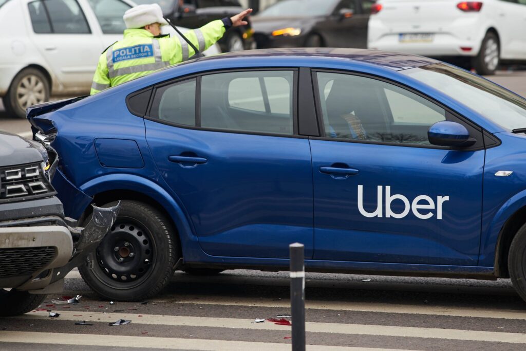 A blue rideshare vehicle involved in a rear end collision illustrates complex insurance claims represented by St Petersburg Uber Accident Lawyers.
