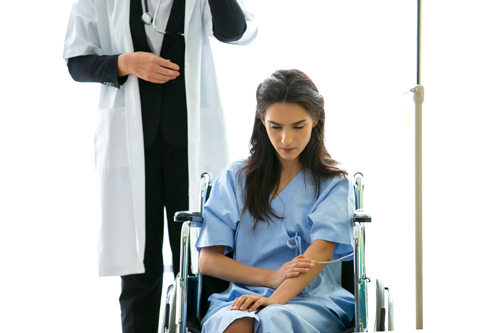 Doctor speaking with an injured patient during a medical appointment after an assault.