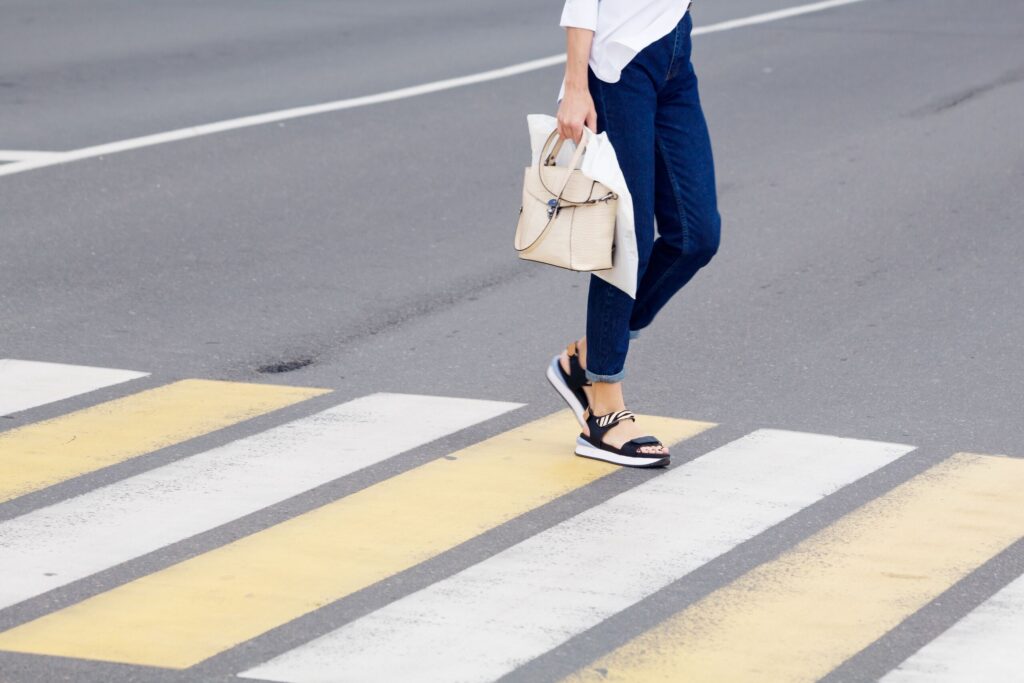 Pedestrian crossing crosswalk in Clearwater illustrating right-of-way laws and driver responsibilities in Florida