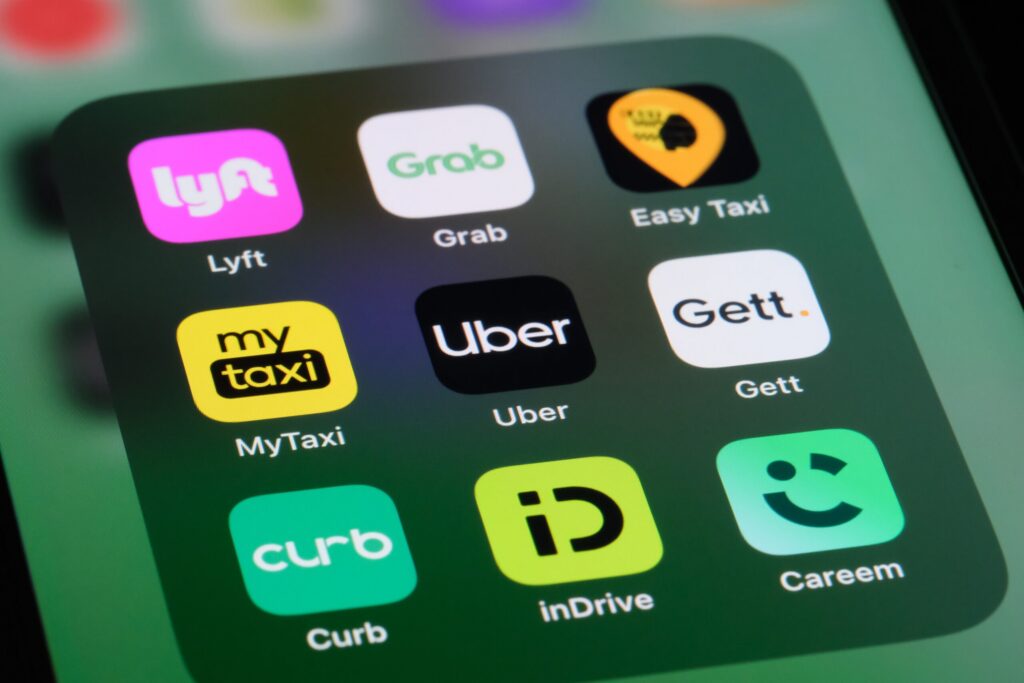 A smartphone screen displaying ride hailing apps related to Uber and Lyft Driver and Vehicle Requirements in Florida.