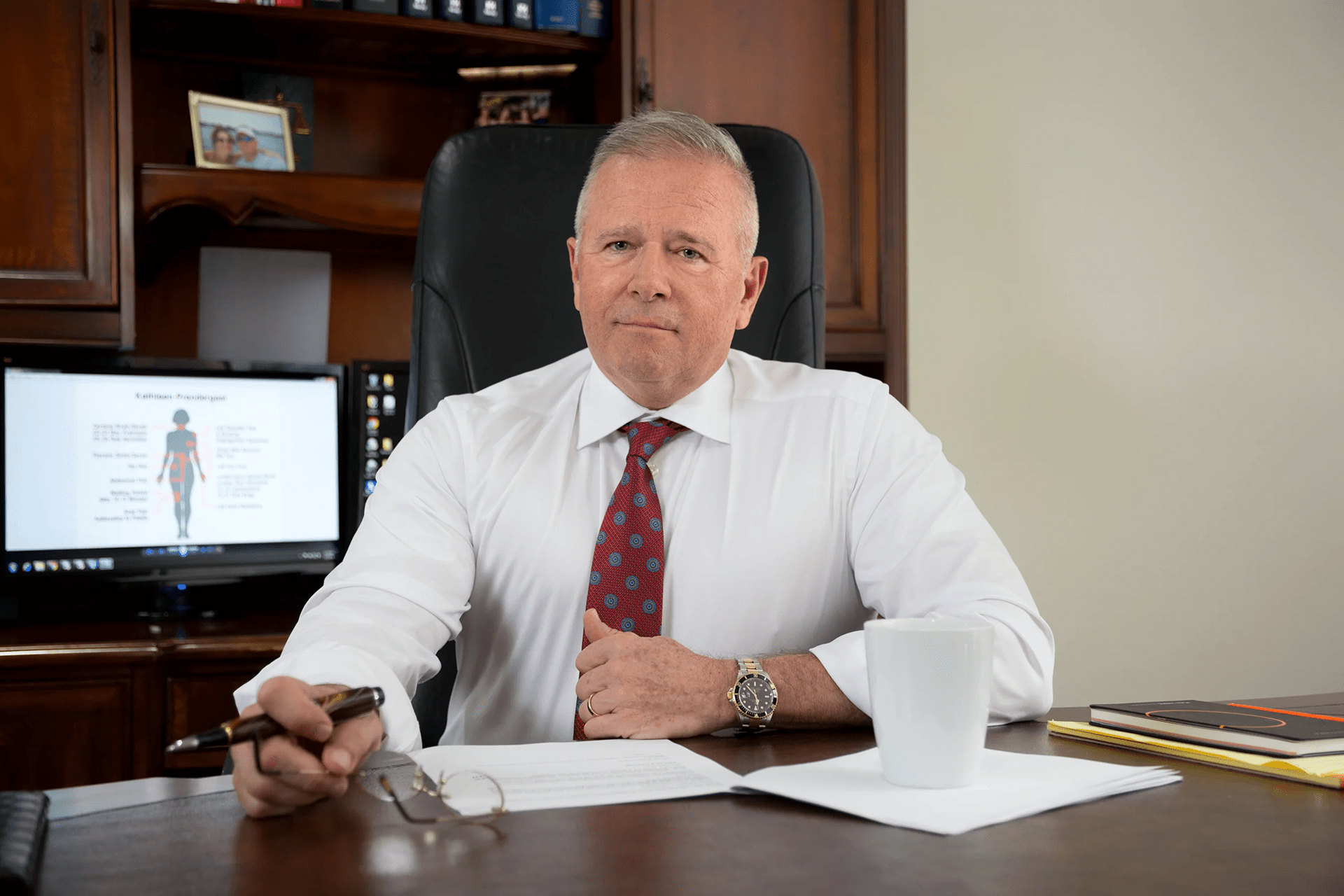 Attorney Mark Roman sitting at desk in office