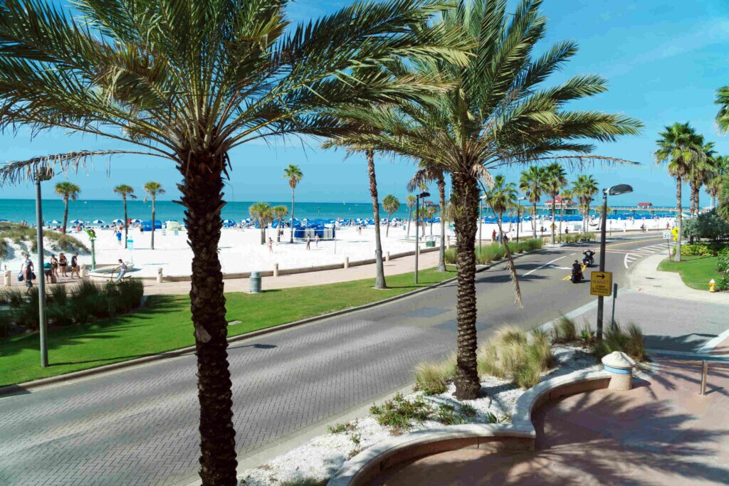 Clearwater pedestrian accident lawyer highlighting busy beach road with heavy foot traffic and vehicles