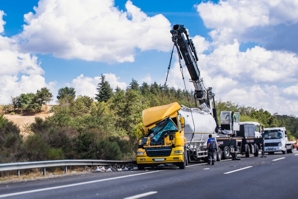 Damaged commercial truck being towed after highway accident representing truck accident cases in Tampa Florida