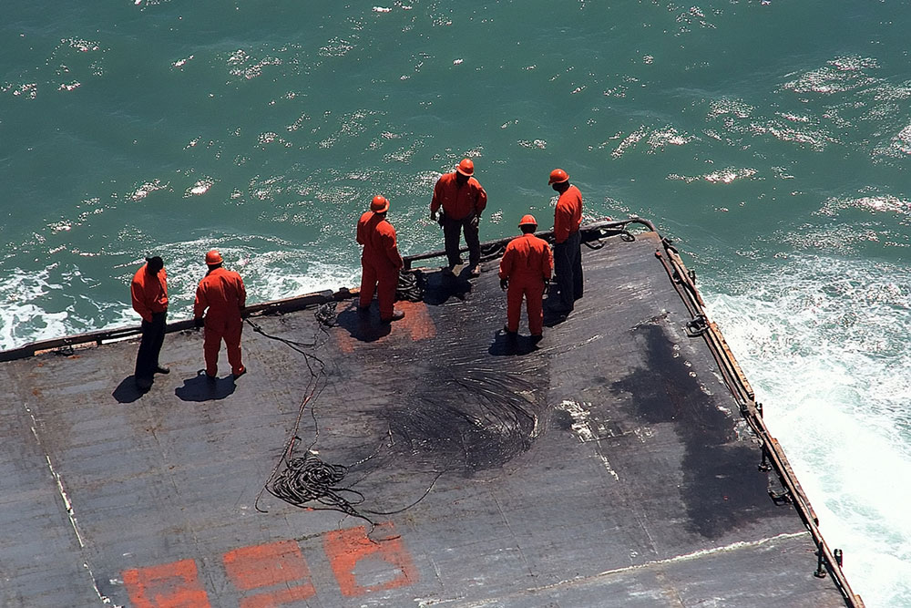 Crew members standing on a ship deck representing seamen and maritime worker injury rights